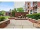 Peaceful brick courtyard with decorative fountains, lush landscaping, and outdoor seating at 1820 Peachtree St # 614, Atlanta, GA 30309