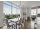 Elegant dining room with floor-to-ceiling windows offering city views and a modern chandelier at 1820 Peachtree St # 614, Atlanta, GA 30309