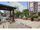 Outdoor grilling area featuring stainless steel grills, brick accents, dining tables, and chairs at 1820 Peachtree St # 614, Atlanta, GA 30309