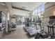 Well-equipped gym featuring treadmills, weight machines, and large windows at 1820 Peachtree St # 614, Atlanta, GA 30309