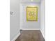 Hallway featuring hardwood floors, white trim, and a framed picture of flowers on the wall at 1820 Peachtree St # 614, Atlanta, GA 30309