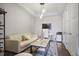 Well-lit home office with a comfortable sofa, desk, and decorative rug, creating an ideal workspace at 1820 Peachtree St # 614, Atlanta, GA 30309