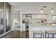 Open-concept kitchen featuring white cabinets, granite countertops, stainless steel appliances, and a breakfast bar at 1820 Peachtree St # 614, Atlanta, GA 30309