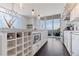 Modern kitchen features white cabinetry, a large island with a wine rack, and floor-to-ceiling windows with balcony access at 1820 Peachtree St # 614, Atlanta, GA 30309