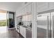 This kitchen includes stainless steel Viking appliances, light countertops, white cabinets and a sliding glass door to a balcony at 1820 Peachtree St # 614, Atlanta, GA 30309