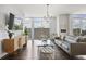 Stylish living room featuring hardwood floors, a comfortable gray sofa, and an elegant glass coffee table at 1820 Peachtree St # 614, Atlanta, GA 30309