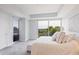 Comfortable bedroom featuring large windows, neutral tones, soft lighting, and scenic outdoor views at 1820 Peachtree St # 614, Atlanta, GA 30309