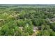 Aerial view showcasing the property's location nestled among mature trees in a desirable neighborhood at 3456 Drayton Ne Dr, Roswell, GA 30075