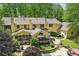 Expansive backyard with a stone patio, lush landscaping, and a charming outdoor dining area perfect for entertaining at 3456 Drayton Ne Dr, Roswell, GA 30075
