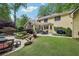The backyard includes a pool, patio, dining area and outdoor lounge seating with lush landscaping at 3456 Drayton Ne Dr, Roswell, GA 30075