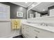 Bathroom features a dual sink vanity with a white countertop and wainscoting at 3456 Drayton Ne Dr, Roswell, GA 30075