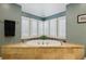 Bathroom features a jacuzzi tub, shuttered windows, and travertine tile at 3456 Drayton Ne Dr, Roswell, GA 30075