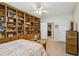 Bedroom boasts large built-in shelving, neutral tones, and adjoins bathroom at 3456 Drayton Ne Dr, Roswell, GA 30075