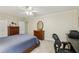 This is a well-lit bedroom with a ceiling fan, a work desk, and neutral paint at 3456 Drayton Ne Dr, Roswell, GA 30075