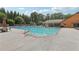 Large community swimming pool with lounge chairs, umbrellas, and a recreation area in the background at 3456 Drayton Ne Dr, Roswell, GA 30075