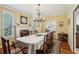Charming dining room features hardwood floors, fireplace, and chandelier at 3456 Drayton Ne Dr, Roswell, GA 30075