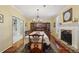 Formal dining room featuring hardwood floors, a fireplace, and elegant chandelier lighting at 3456 Drayton Ne Dr, Roswell, GA 30075