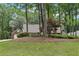 View of a home partially obscured by mature trees, providing a sense of privacy and seclusion at 3456 Drayton Ne Dr, Roswell, GA 30075
