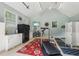 Airy garage featuring gym equipment, a refrigerator, and organized storage solutions at 3456 Drayton Ne Dr, Roswell, GA 30075
