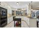 Bright kitchen with granite counters, island, stainless appliances, and bay window at 3456 Drayton Ne Dr, Roswell, GA 30075