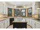 Updated kitchen featuring granite countertops, bay window, and custom cabinetry at 3456 Drayton Ne Dr, Roswell, GA 30075
