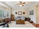 Cozy living room with wood floors, a neutral palette, and a bay window for natural light at 3456 Drayton Ne Dr, Roswell, GA 30075