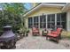 Covered outdoor seating area with comfortable wicker chairs and a stone patio with fire pit at 3456 Drayton Ne Dr, Roswell, GA 30075