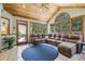 Bright sunroom with wood ceiling, tile floors, and large windows offering natural light and view at 3456 Drayton Ne Dr, Roswell, GA 30075