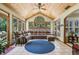 Cozy sunroom featuring wood ceiling, tile floors, large windows, and comfortable seating at 3456 Drayton Ne Dr, Roswell, GA 30075