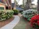 Charming walkway leading to a home with lush landscaping, vibrant azaleas, and a serene setting at 3456 Drayton Ne Dr, Roswell, GA 30075