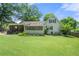 Spacious backyard with lush green lawn, screened porch, and mature trees perfect for outdoor activities at 503 Bonnie Dr, Woodstock, GA 30188