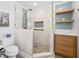 Updated bathroom with large glass shower, stone tile, a rain shower head, and wood shelving at 503 Bonnie Dr, Woodstock, GA 30188