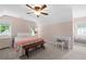 Comfortable bedroom with pastel pink walls, chair railing, and a large bright window at 503 Bonnie Dr, Woodstock, GA 30188