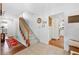 Welcoming foyer with stairs, hardwood floors, and views into the kitchen and other rooms at 503 Bonnie Dr, Woodstock, GA 30188
