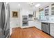 Spacious kitchen with stainless steel double ovens, bright white cabinets, and modern appliances at 503 Bonnie Dr, Woodstock, GA 30188