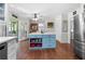 Well-lit kitchen with a central island, stainless steel appliances, and hardwood flooring at 503 Bonnie Dr, Woodstock, GA 30188
