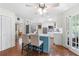 Open kitchen featuring a blue island with seating, stainless appliances, and hardwood floors at 503 Bonnie Dr, Woodstock, GA 30188