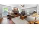 Inviting living room with a brick fireplace, hardwood floors, and large windows for natural light at 503 Bonnie Dr, Woodstock, GA 30188