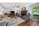 Bright and airy living room with hardwood floors, a fireplace, and large windows overlooking the yard at 503 Bonnie Dr, Woodstock, GA 30188