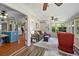 Comfortable sunroom with multiple windows, a ceiling fan, and hardwood floors overlooking the kitchen at 503 Bonnie Dr, Woodstock, GA 30188