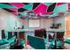 Finished basement featuring custom ceiling design, bar seating, projector and screen setup, and games at 1023 Bentley Estates Dr, Dacula, GA 30019