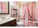 Chic bathroom with an elegant shower curtain, decorative mirror, and a modern vanity with ample counter space at 1023 Bentley Estates Dr, Dacula, GA 30019