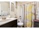 Bright bathroom featuring a shower-tub combo, decorative shower curtain, and a modern vanity at 1023 Bentley Estates Dr, Dacula, GA 30019