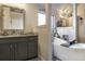 Elegant bathroom with soaking tub, vanity with granite countertop, and refined fixtures for a luxurious feel at 1023 Bentley Estates Dr, Dacula, GA 30019