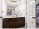 Clean bathroom showcasing vanity with modern fixtures, a large mirror, and a shower-tub combo for everyday convenience at 1023 Bentley Estates Dr, Dacula, GA 30019