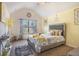 Charming bedroom with vaulted ceiling, large window, and stylish decor creating a cozy retreat at 1023 Bentley Estates Dr, Dacula, GA 30019