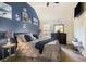 Comfortable bedroom with tasteful nautical theme, accent wall, and modern furnishings for a relaxing atmosphere at 1023 Bentley Estates Dr, Dacula, GA 30019