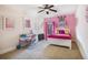 Bright bedroom with a desk, bed, and a window bringing in natural light, creating a comfortable space at 1023 Bentley Estates Dr, Dacula, GA 30019