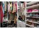 Organized walk-in closet offers ample storage with custom shelving and hanging space for clothes and accessories at 1023 Bentley Estates Dr, Dacula, GA 30019