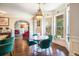 Bright dining area features a bay window, chandelier, and access to living room at 1023 Bentley Estates Dr, Dacula, GA 30019
